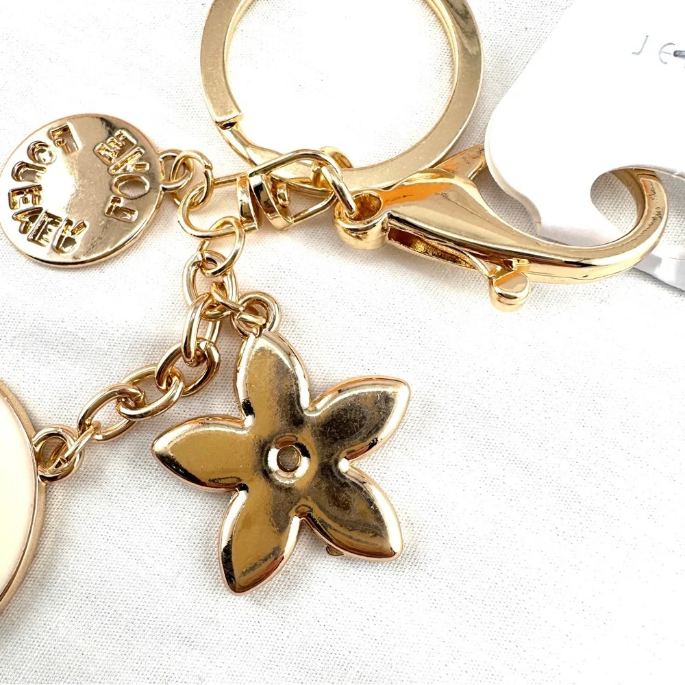 Unbranded keychain or purse charm. Gold and black. NEW.